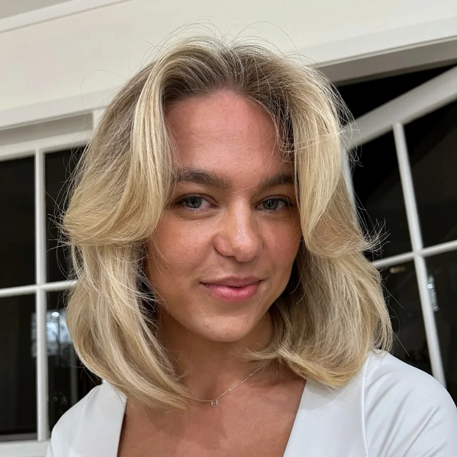 shoulder wavy blonde layers with curtain fringe shown as a medium length haircuts for thick hair idea
