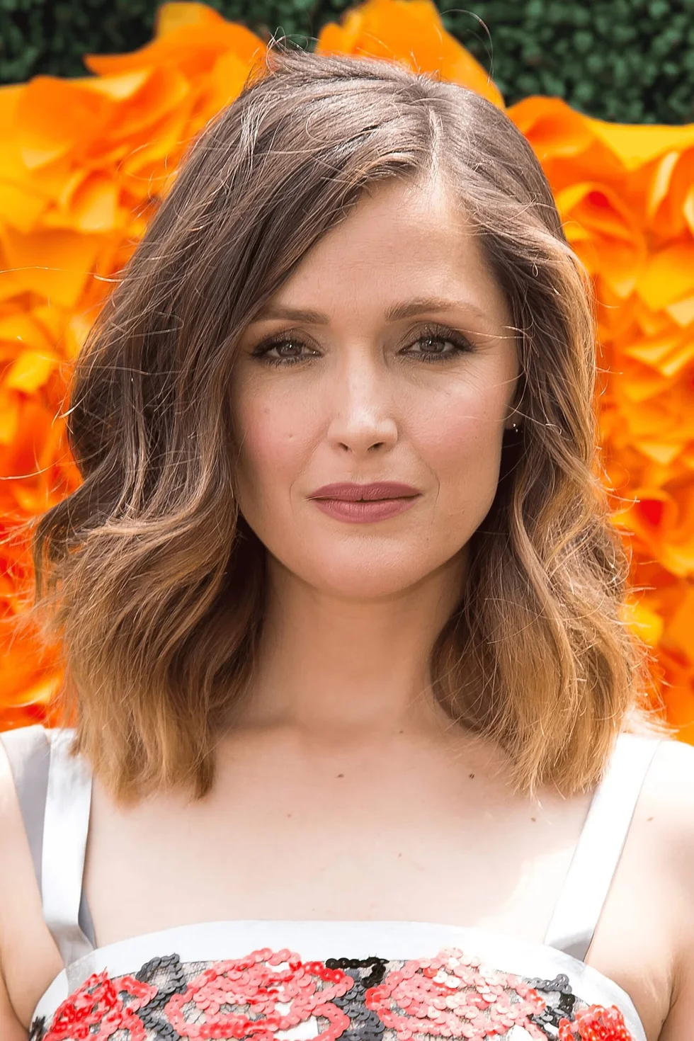 shoulder wavy chestnut shag with curtain fringe shown as a medium length haircuts for thick hair idea, featuring wavy texture