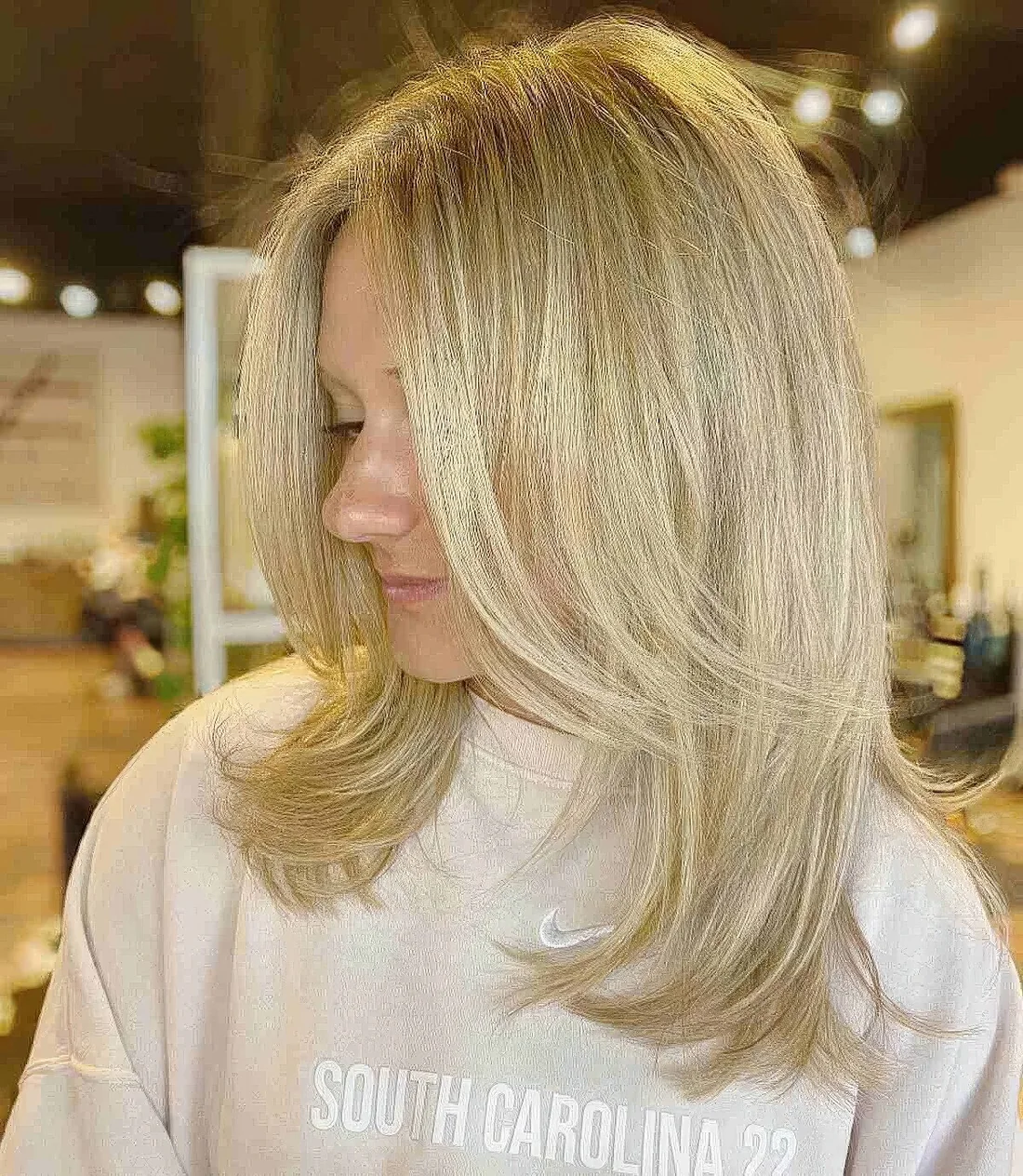 Photo showing medium blonde straight wolf cut, with the hairstyle clearly visible.