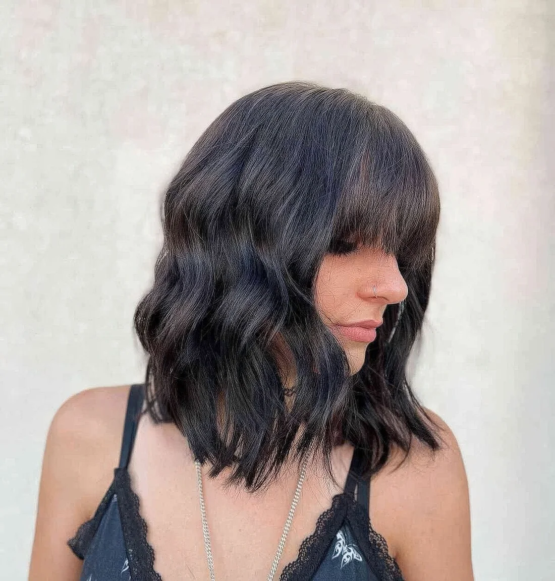 Medium haircut with bangs and waves.