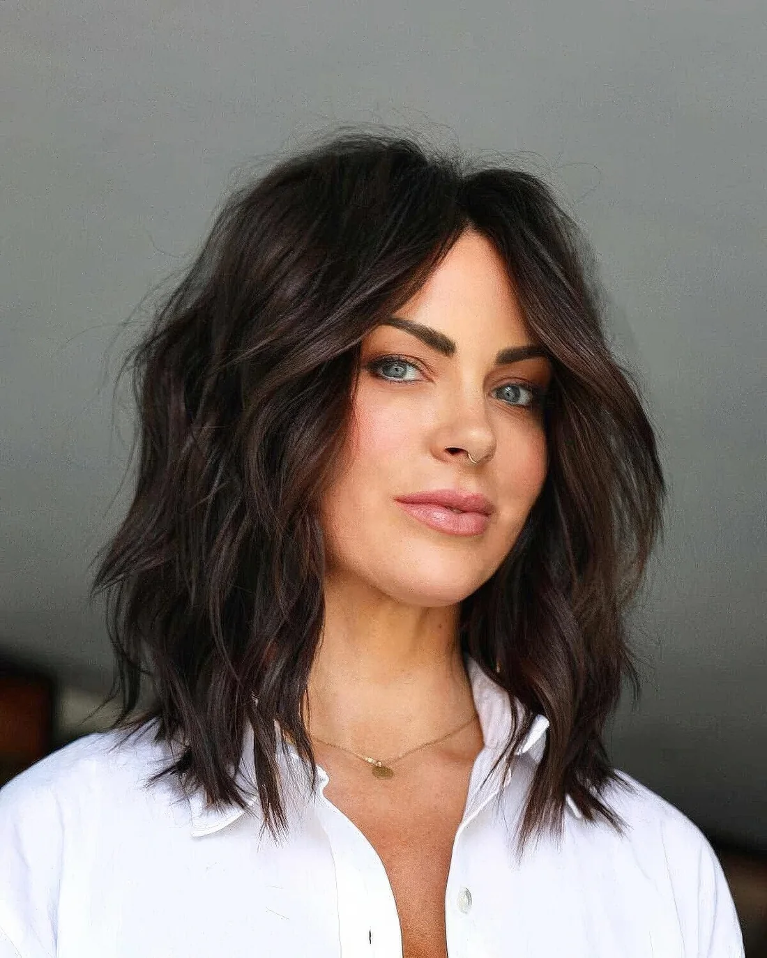 Modern mid length shag with a middle part.