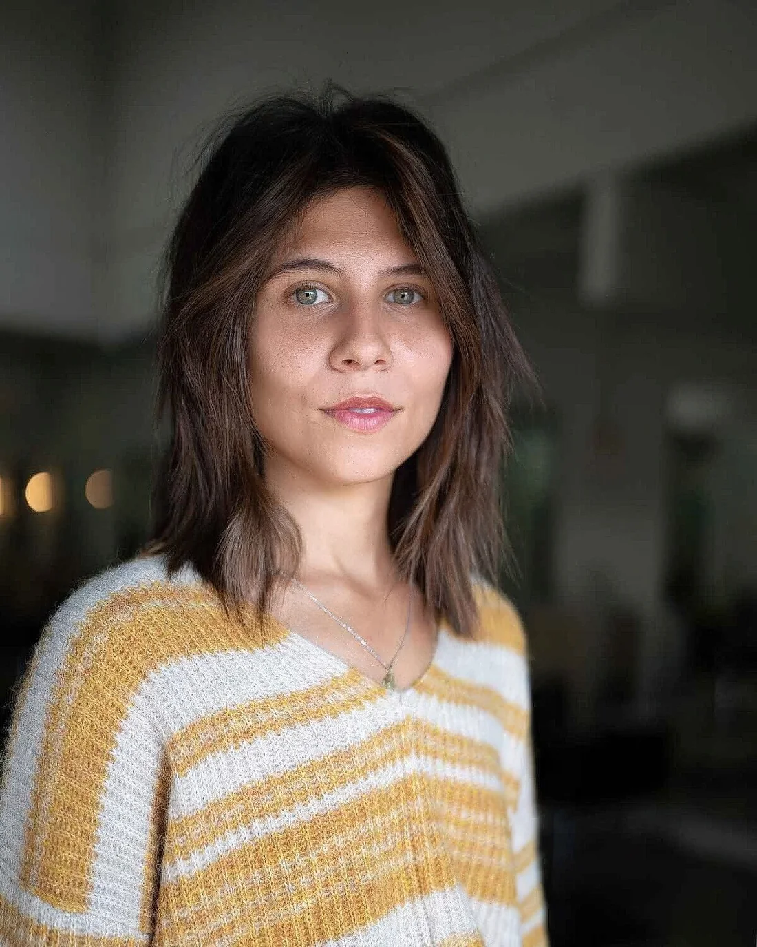 Soft shoulder-length cut on straight dark hair.