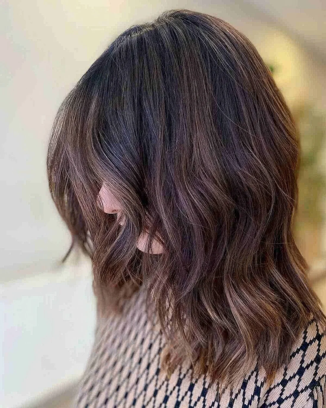 Soft shoulder-length haircut with layers and textured ends.