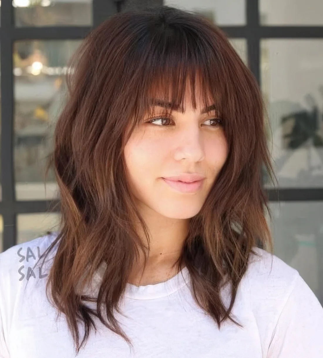 Layered long bob with wispy bangs, shaggy layers for a bit of grunge.