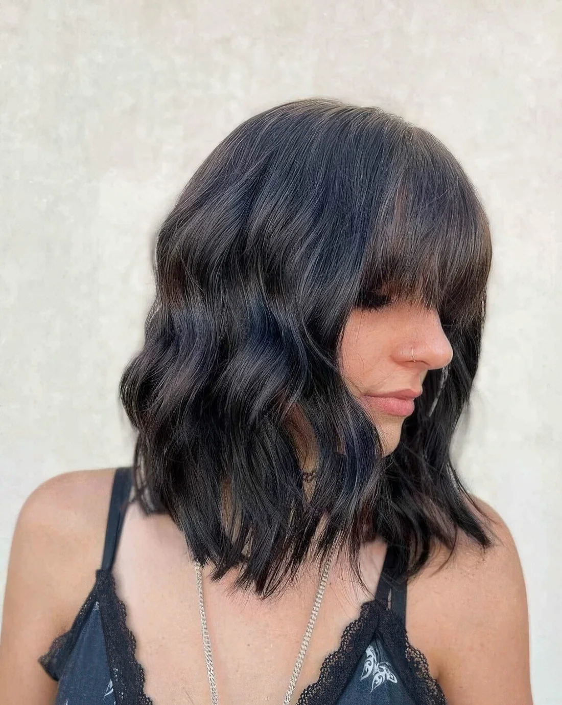 Medium haircut with bangs and waves.