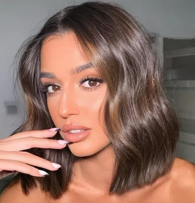 Photo showing shiny wavy lob, with the hairstyle clearly visible.