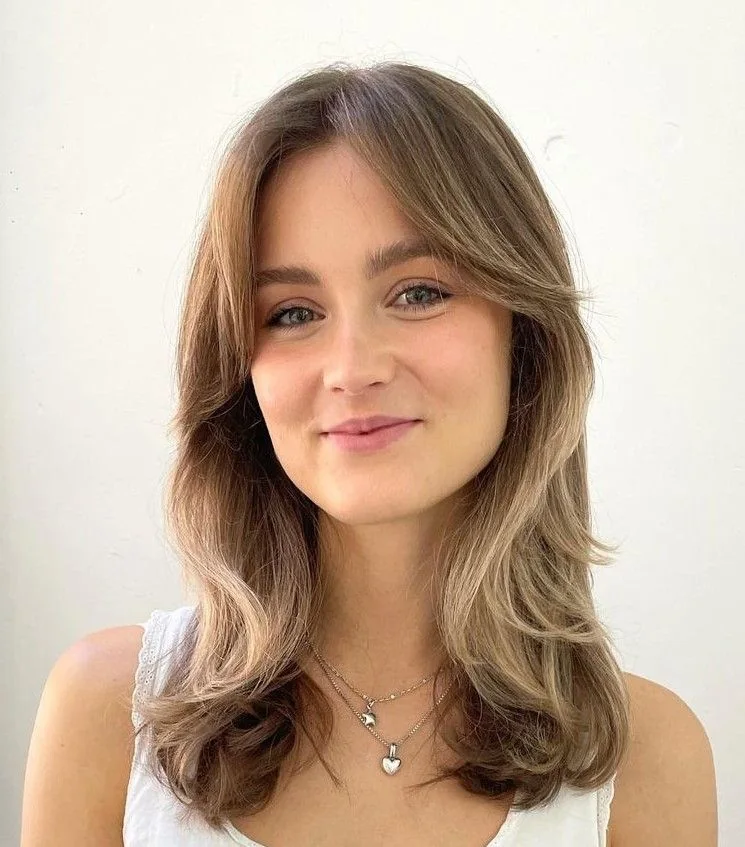 Photo showing layered medium cut, with the hairstyle clearly visible.