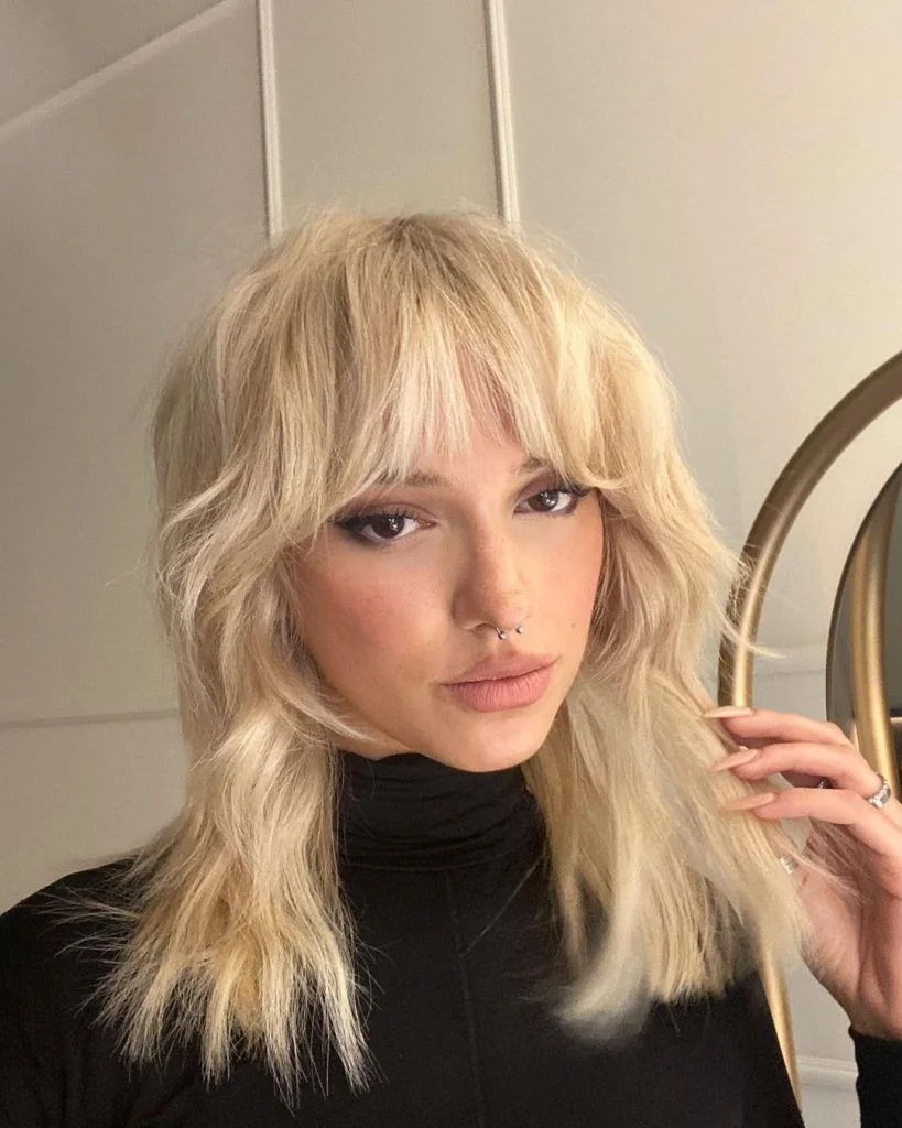 Photo showing shaggy cut layered bangs, with the hairstyle clearly visible.