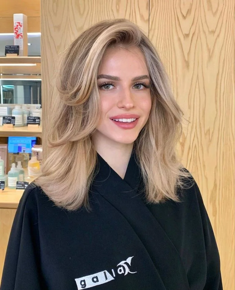 Photo showing butterfly blonde cut, with the hairstyle clearly visible.