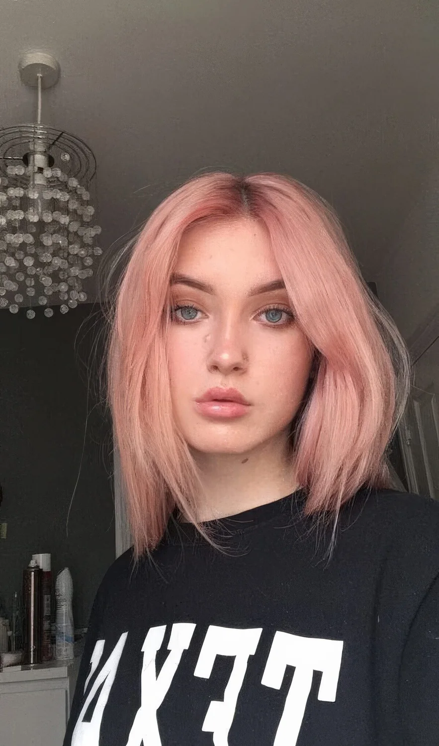 Warm pastel strawberry blonde with a darker root and much texture.