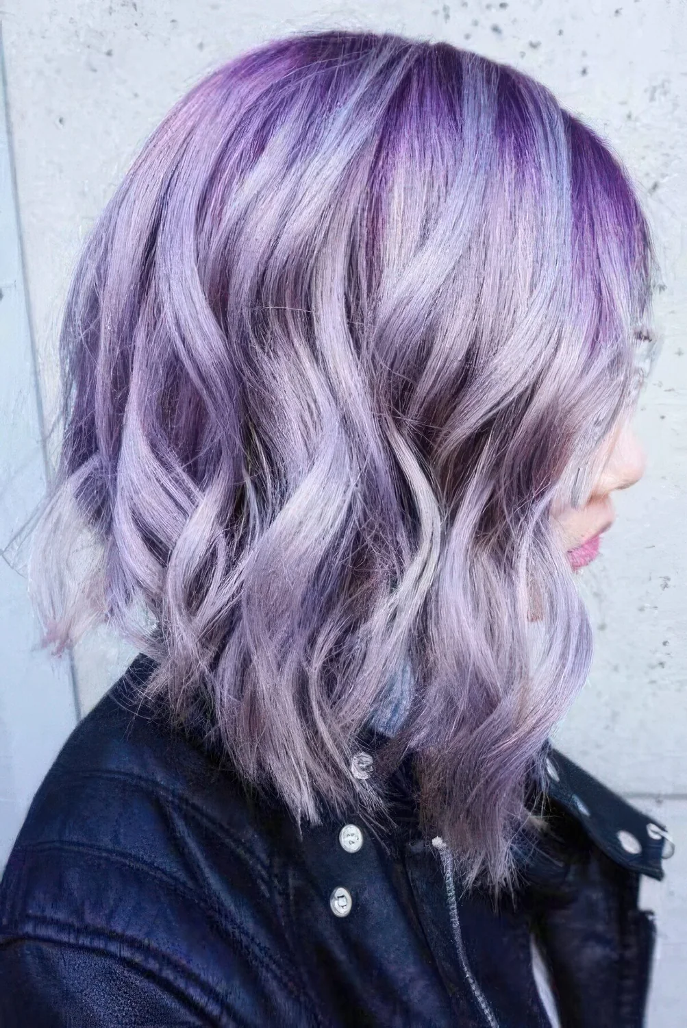 Asymmetrical long wavy bob with purple and lilac hair and waves.