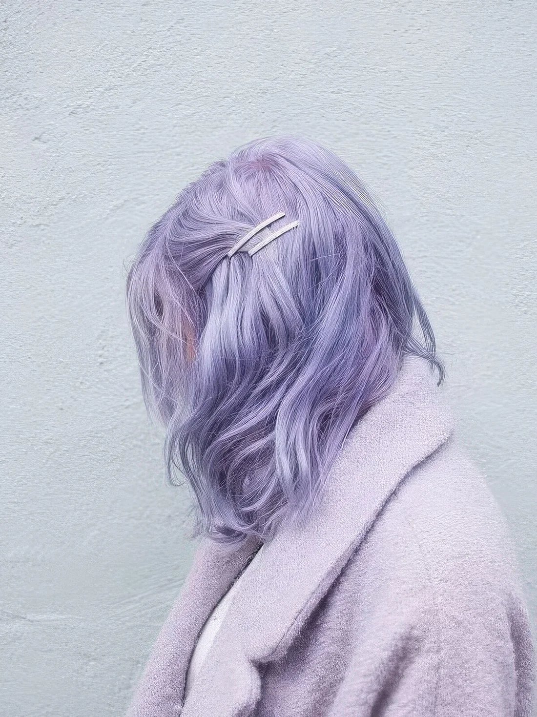 Pastel purple messy and wavy long bob with side bangs.