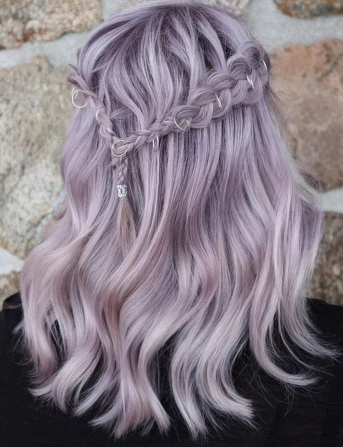 Romantic lilac half-up hairstyle with a braided halo and waves.