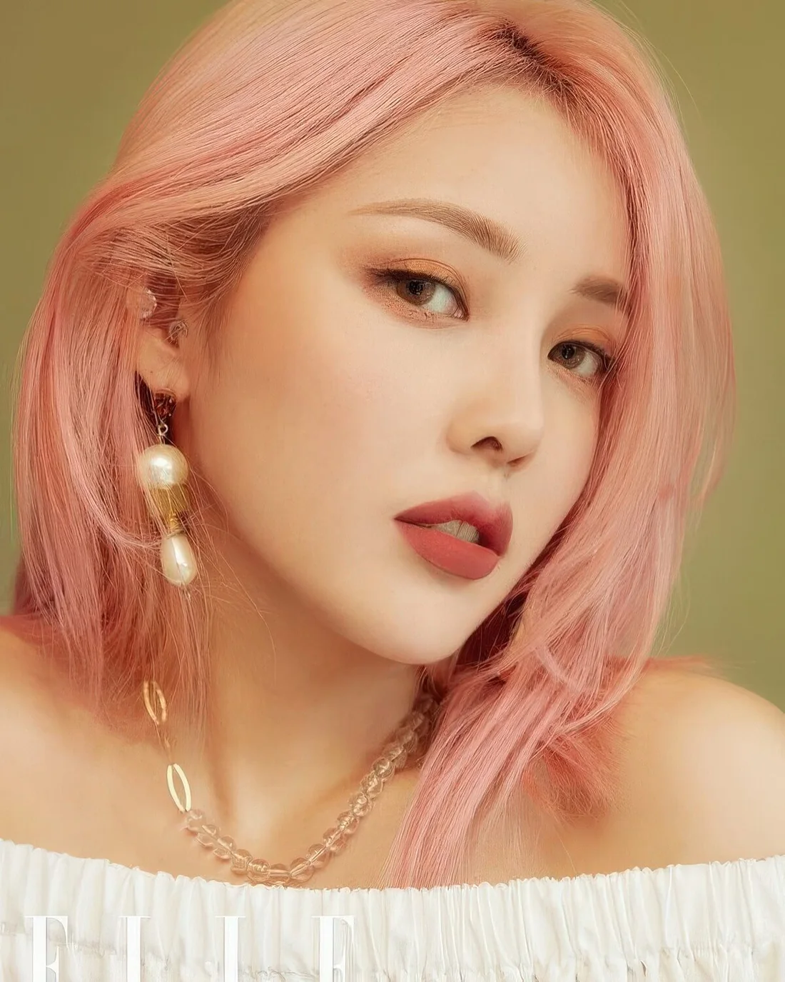 Pastel pink shoulder-length hair with a bit of texture.