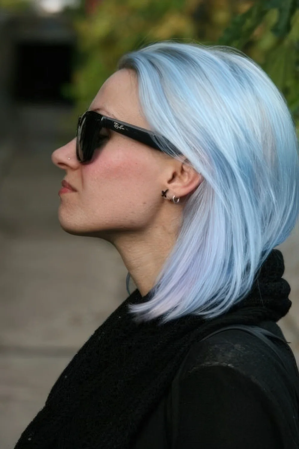 Shoulder-length pastel blue hair with touches of silver.