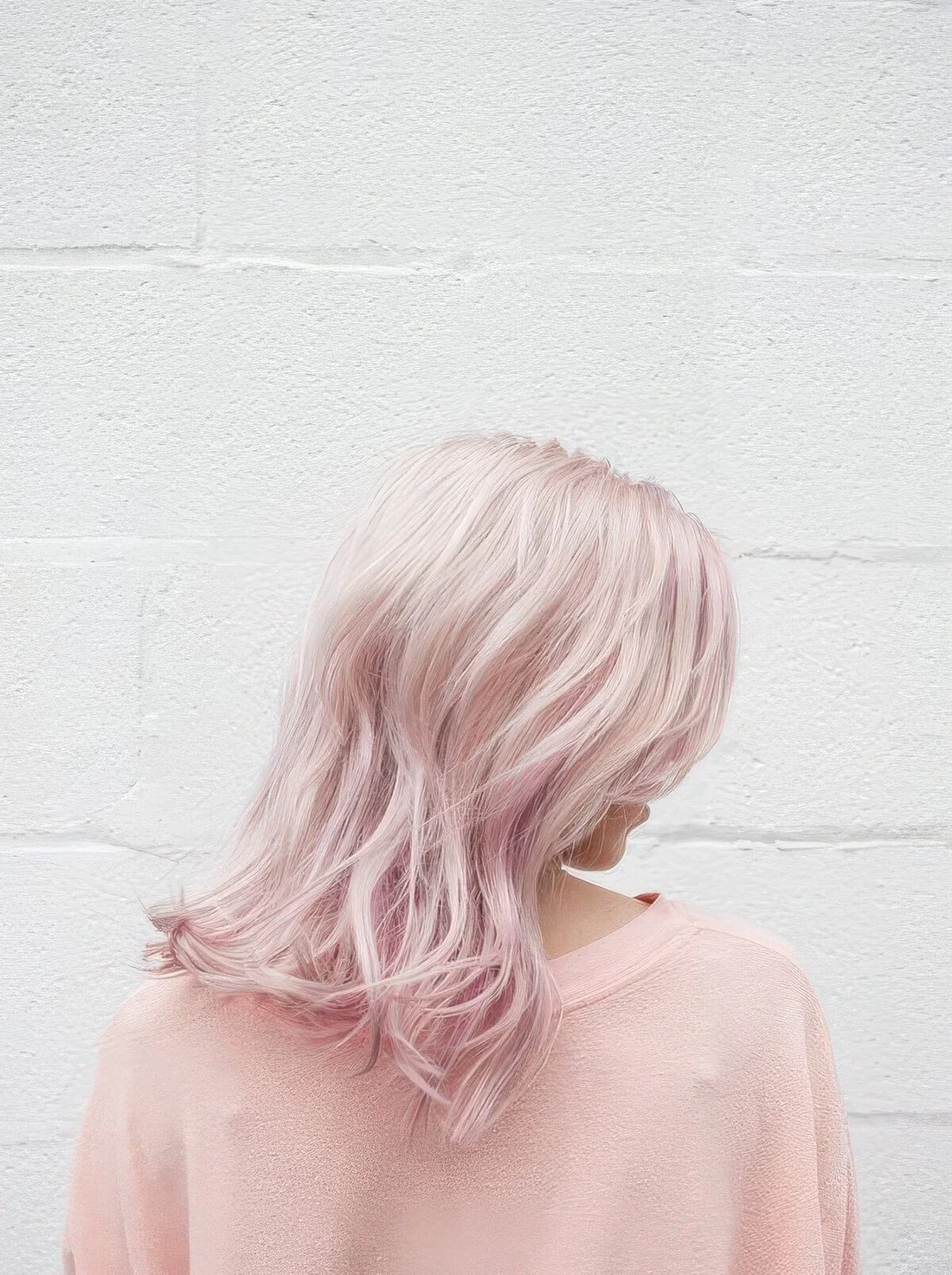 Medium-length pale pink hair with messy waves.