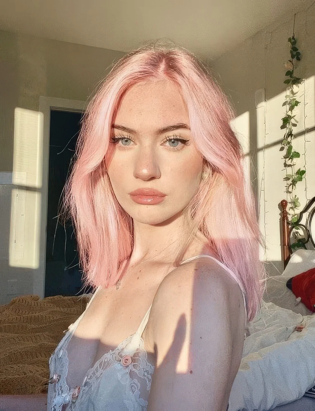 Pastel pink medium-length hair with some volume.