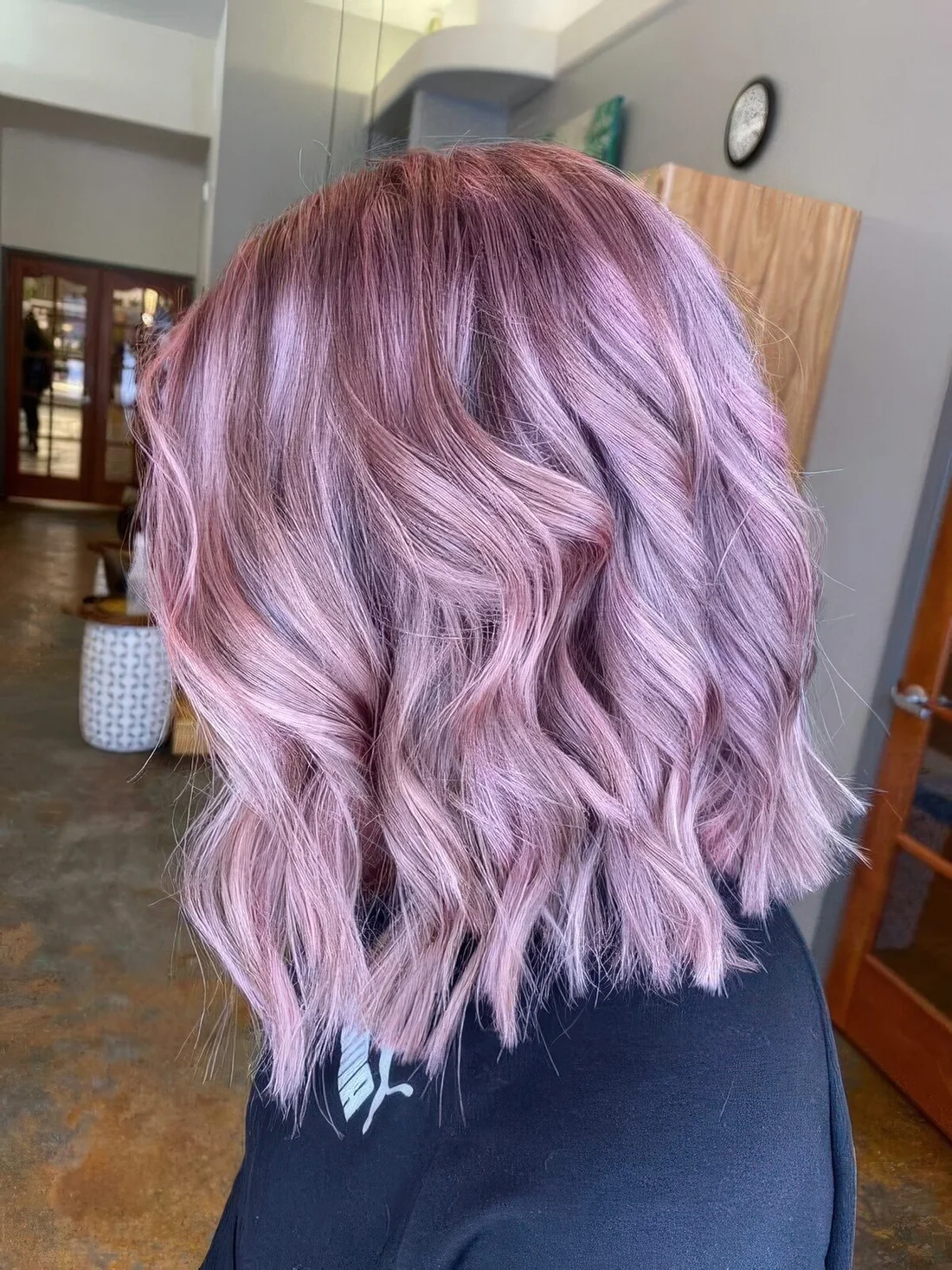 Ashy pink shoulder-length hair with waves.