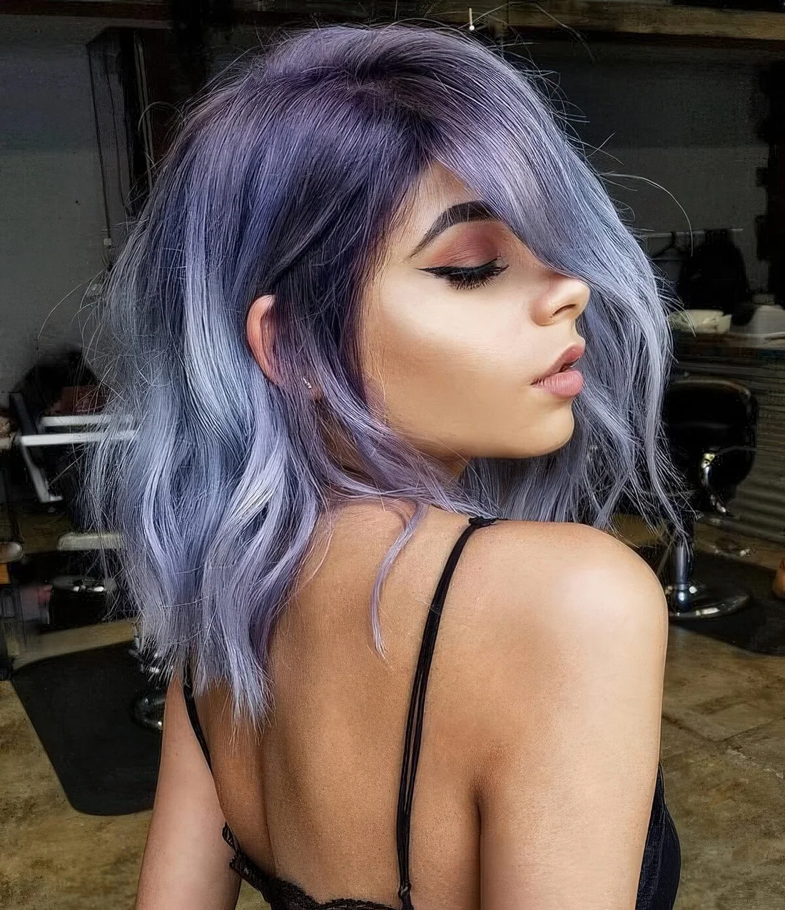 Medium-length blue and purple hair with some textural waves.