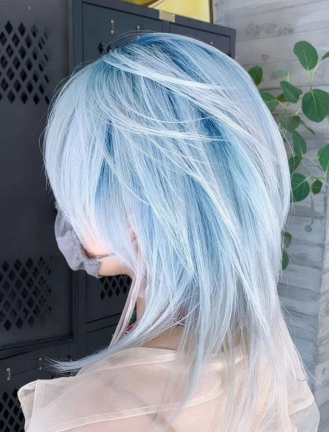 Pastel blue hair of a super delicate shade, with a mallet haircut.