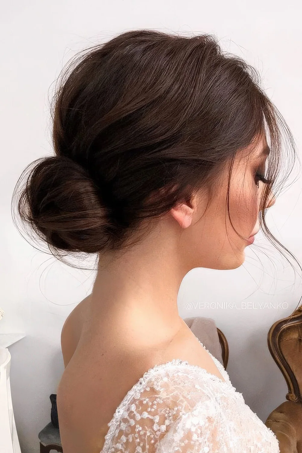Low bun with a bump on top, some hair down.
