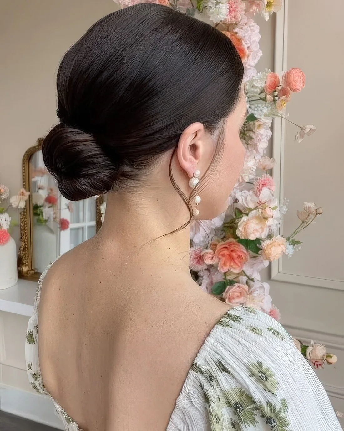 Photo showing low bun with a tight top, with the hairstyle clearly visible.