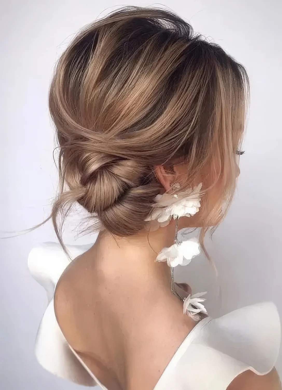 Side twisted bun with a volume on top, some locks down and a bit of mess for a gorgeous look.
