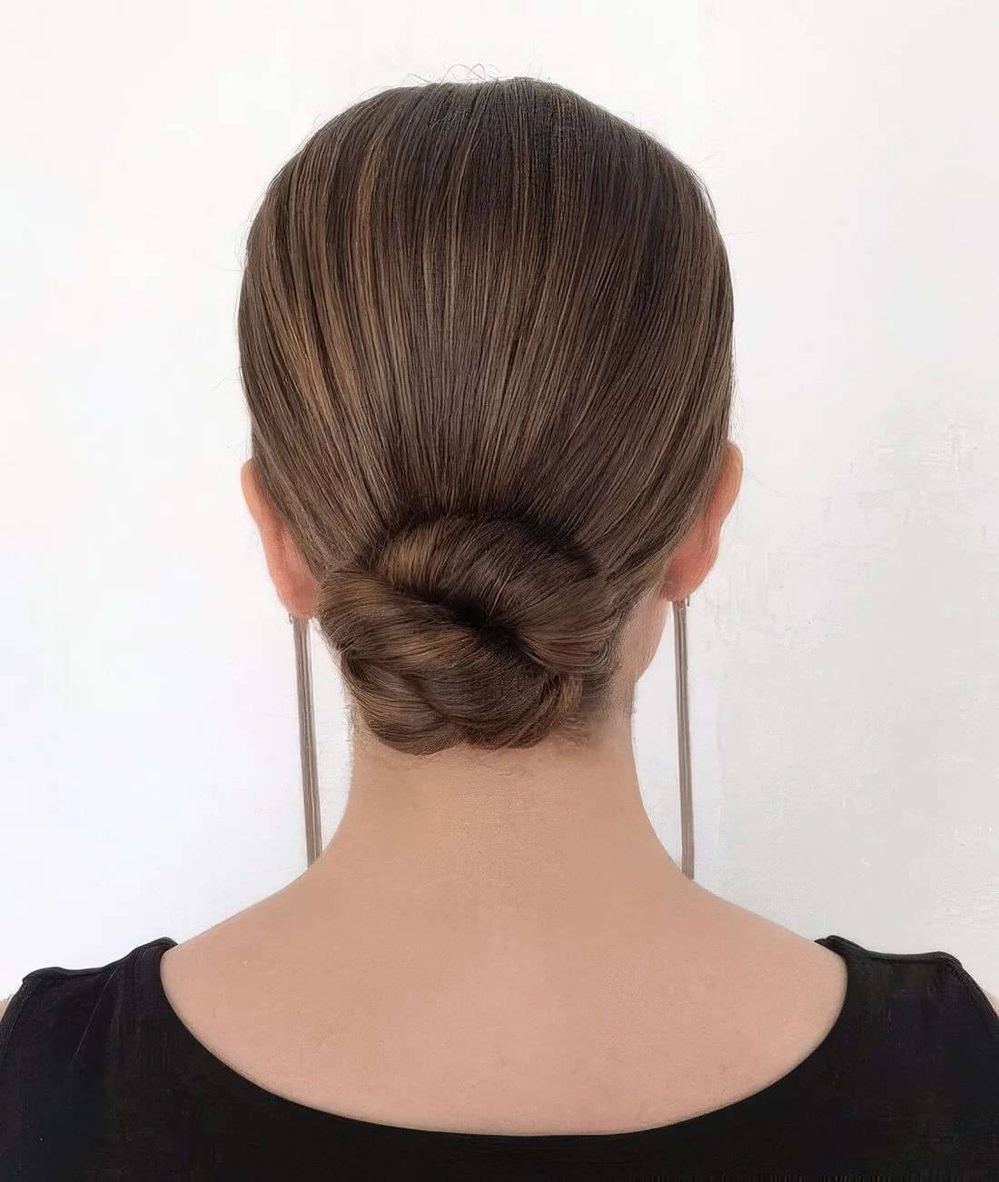 Twisted low bun with a tight and sleek top.