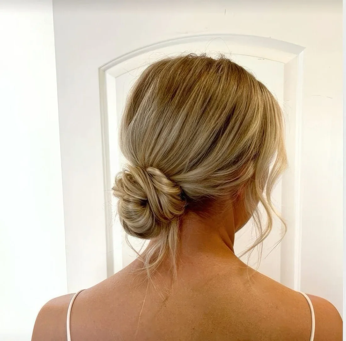 Messy low bun with face-framing hair.