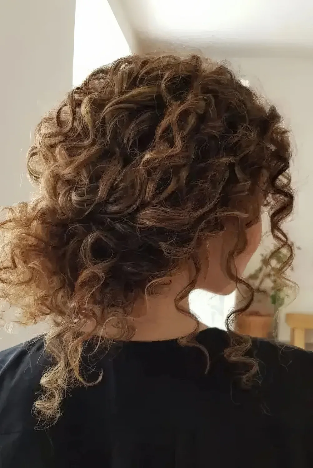 Curly wedding hairstyle with bangs.