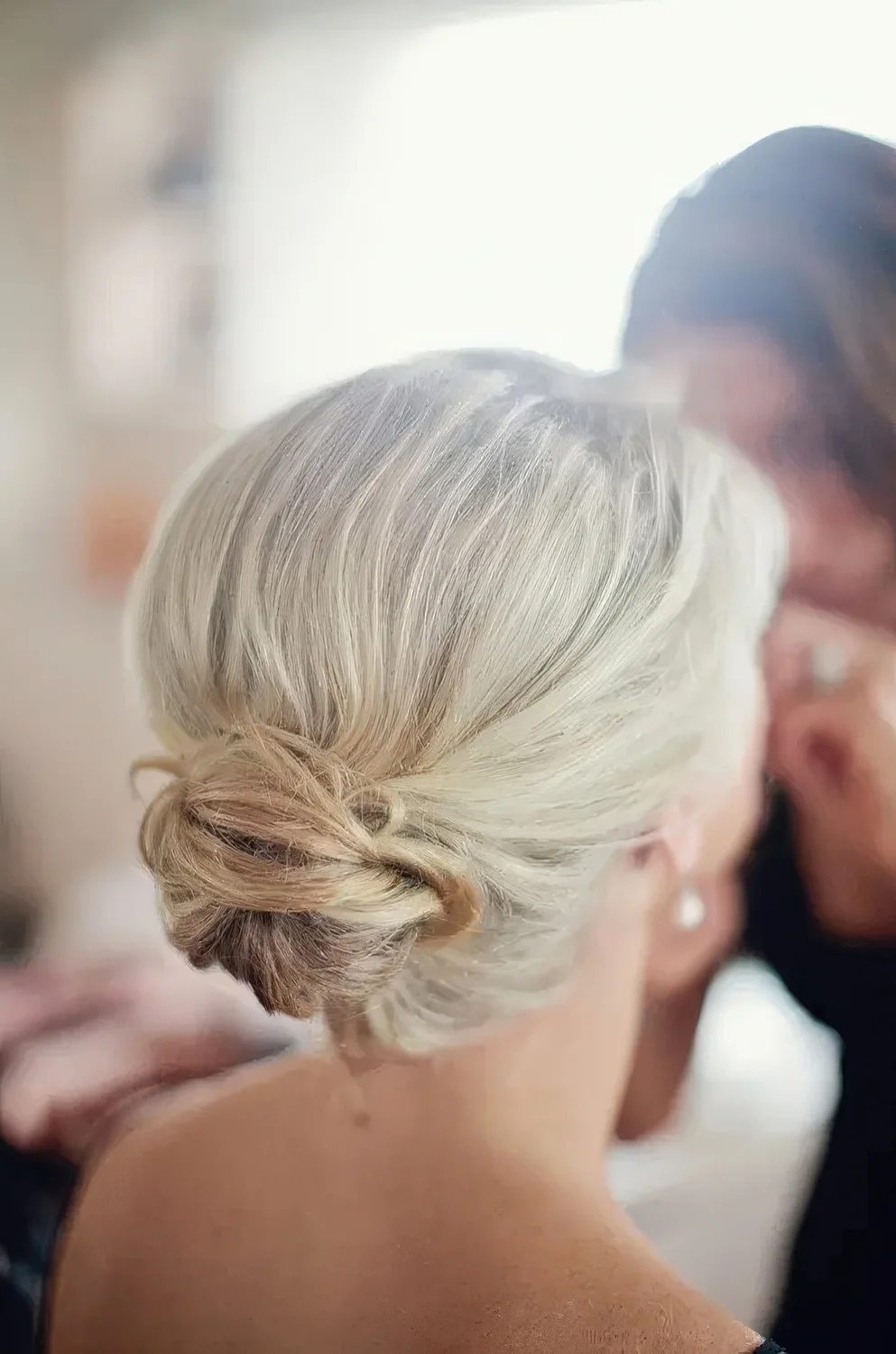 Chic textured low bun with a volume on top.