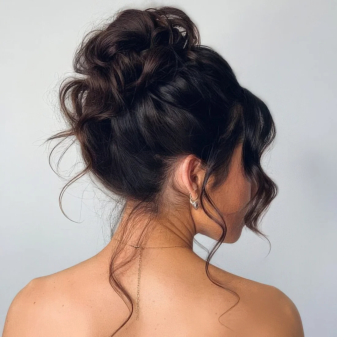Photo showing messy updo for a wedding, with the hairstyle clearly visible.