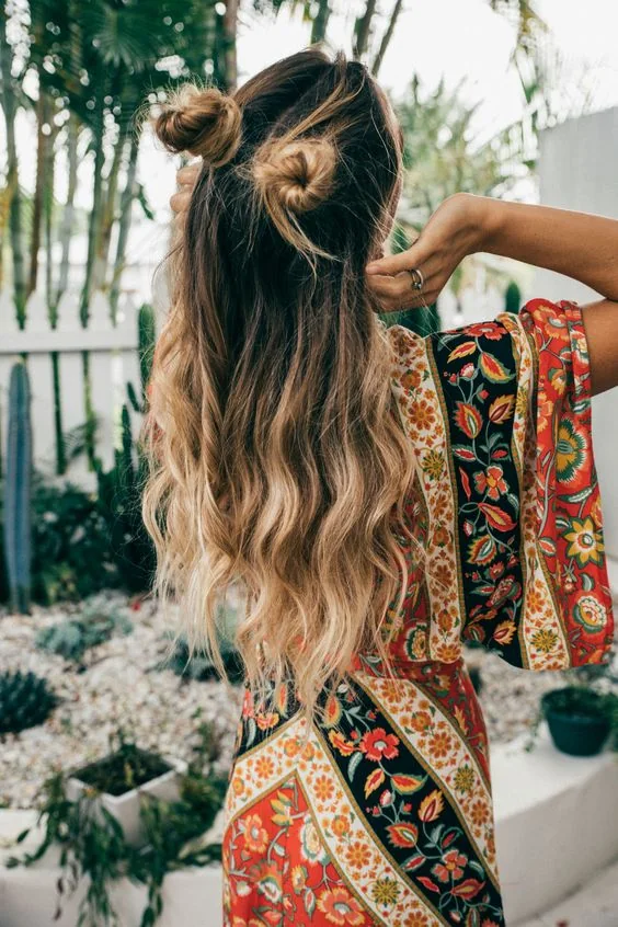 Half updo with long waves down and two funny buns.