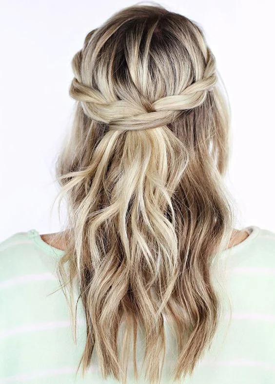 Half updo with twists and loose waves down.