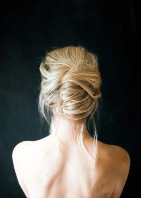 Loose and messy summer updo with some hair down.