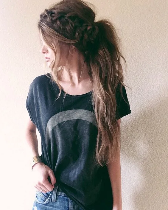 Loose and messy low ponytail with a large braid and some hair down.