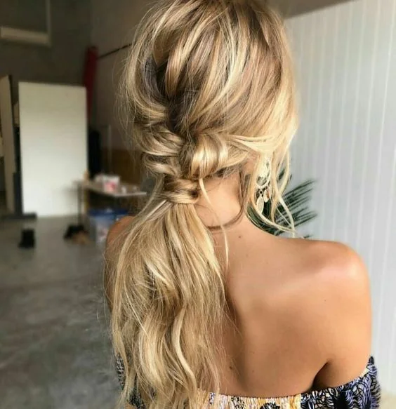 Photo showing loose low and messy ponytail, with the hairstyle clearly visible.