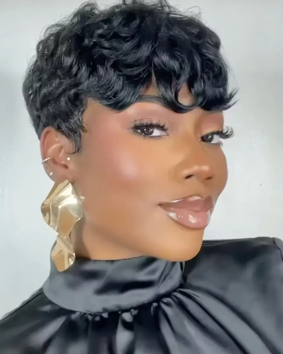 ear coily black pixie with side swept fringe shown as a messy pixie cut with bangs idea