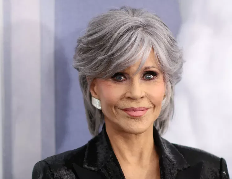 ear straight silver pixie with side swept fringe shown as a messy pixie cut with bangs idea