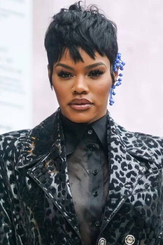 ear curly black pixie with curly fringe fringe shown as a messy pixie cut with bangs idea