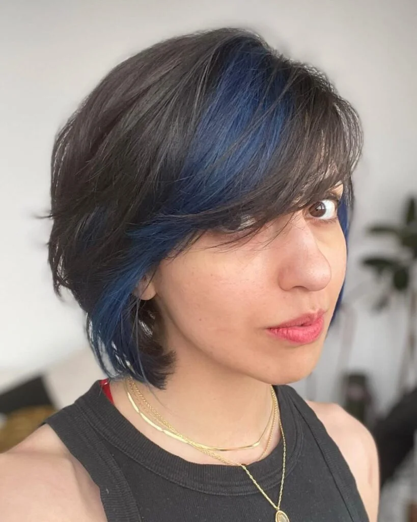 ear straight golden pixie with wispy fringe shown as a messy pixie cut with bangs idea