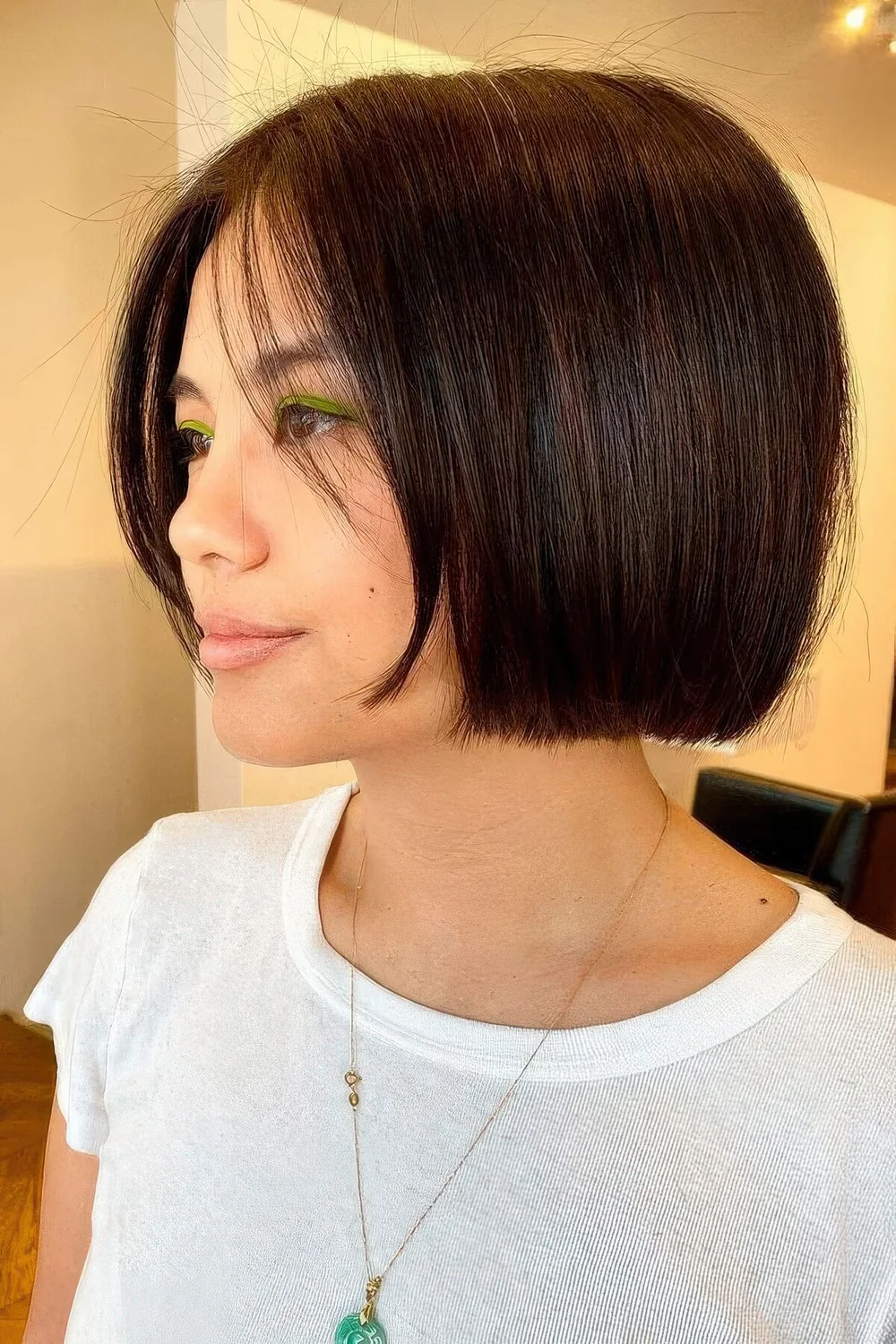 Black jaw-length bob with center part and a shiny finish.