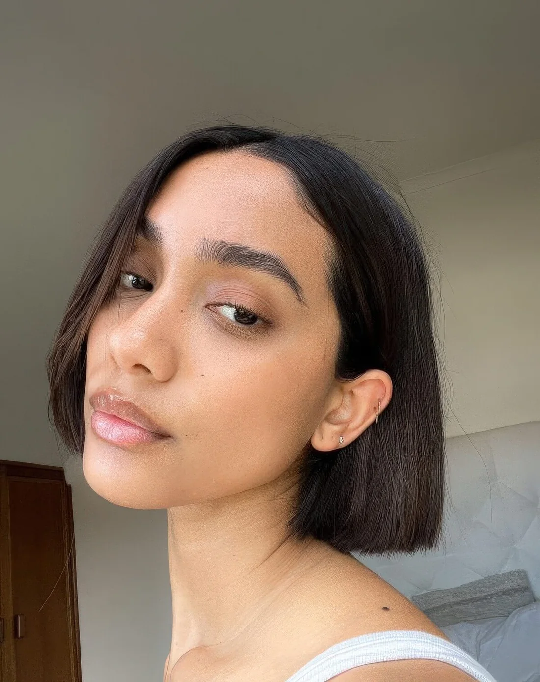 Photo showing blunt micro bob with center part, with the hairstyle clearly visible.
