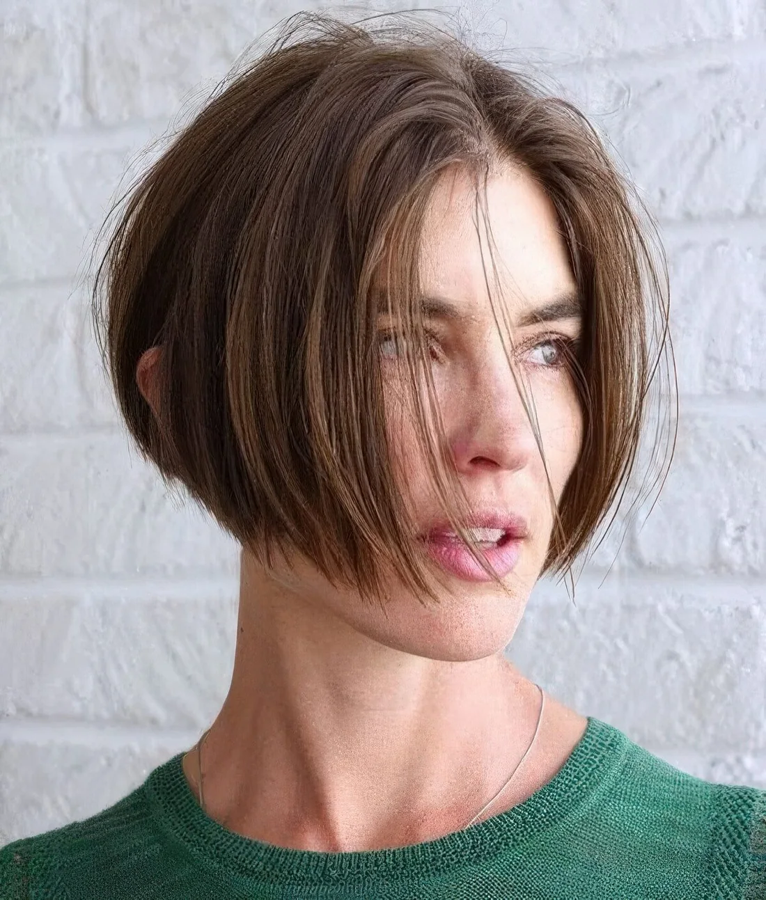 Breezy A line brown lip length bob with much volume and center part.