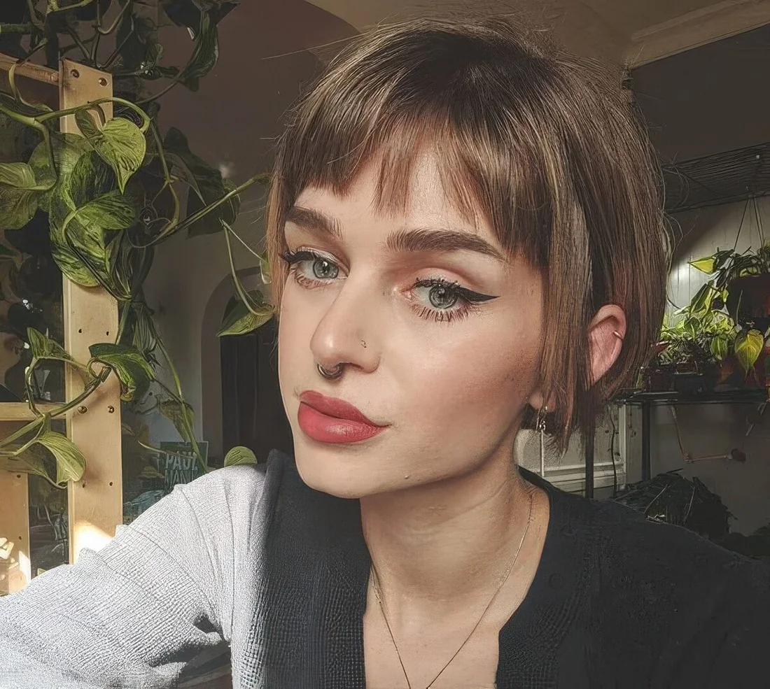 Brown cheekbone bob with wispy bangs.