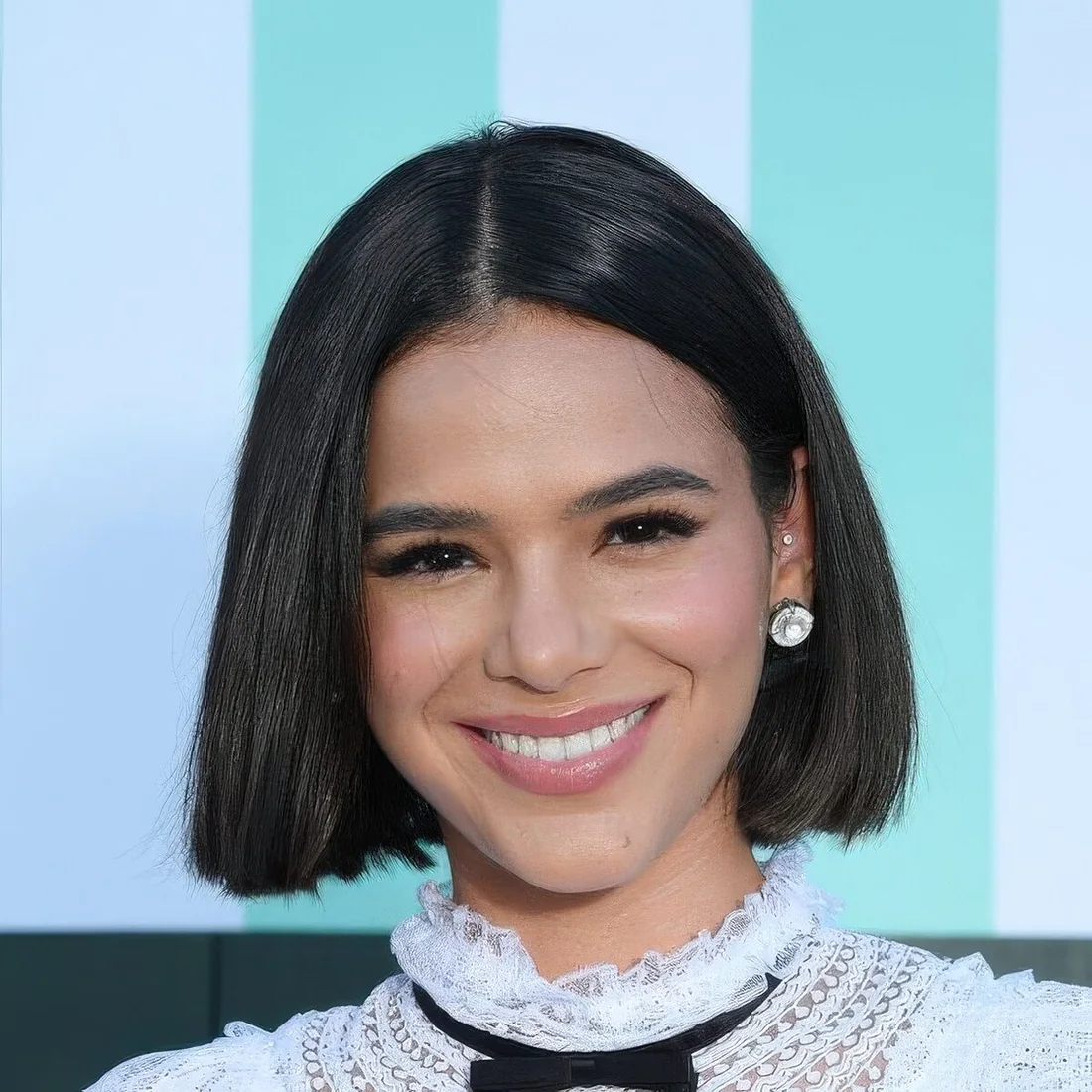 Sleek yet voluminous black chin-length bob with center part never goes out of style.