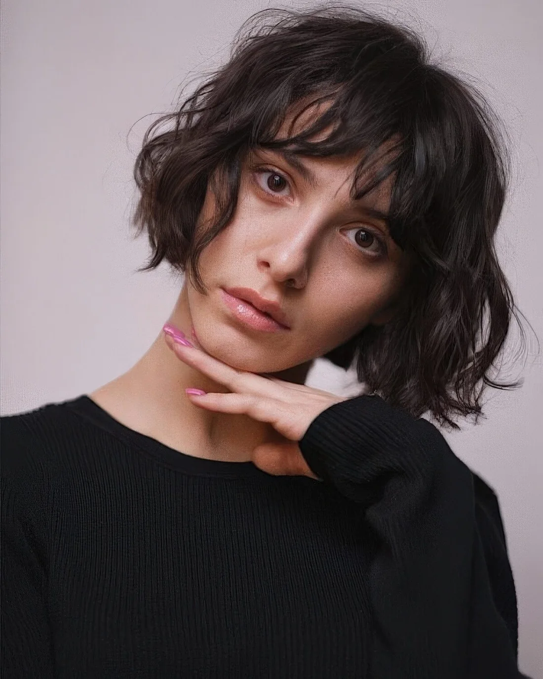 Wavy dark brown line line bob with messy bangs.