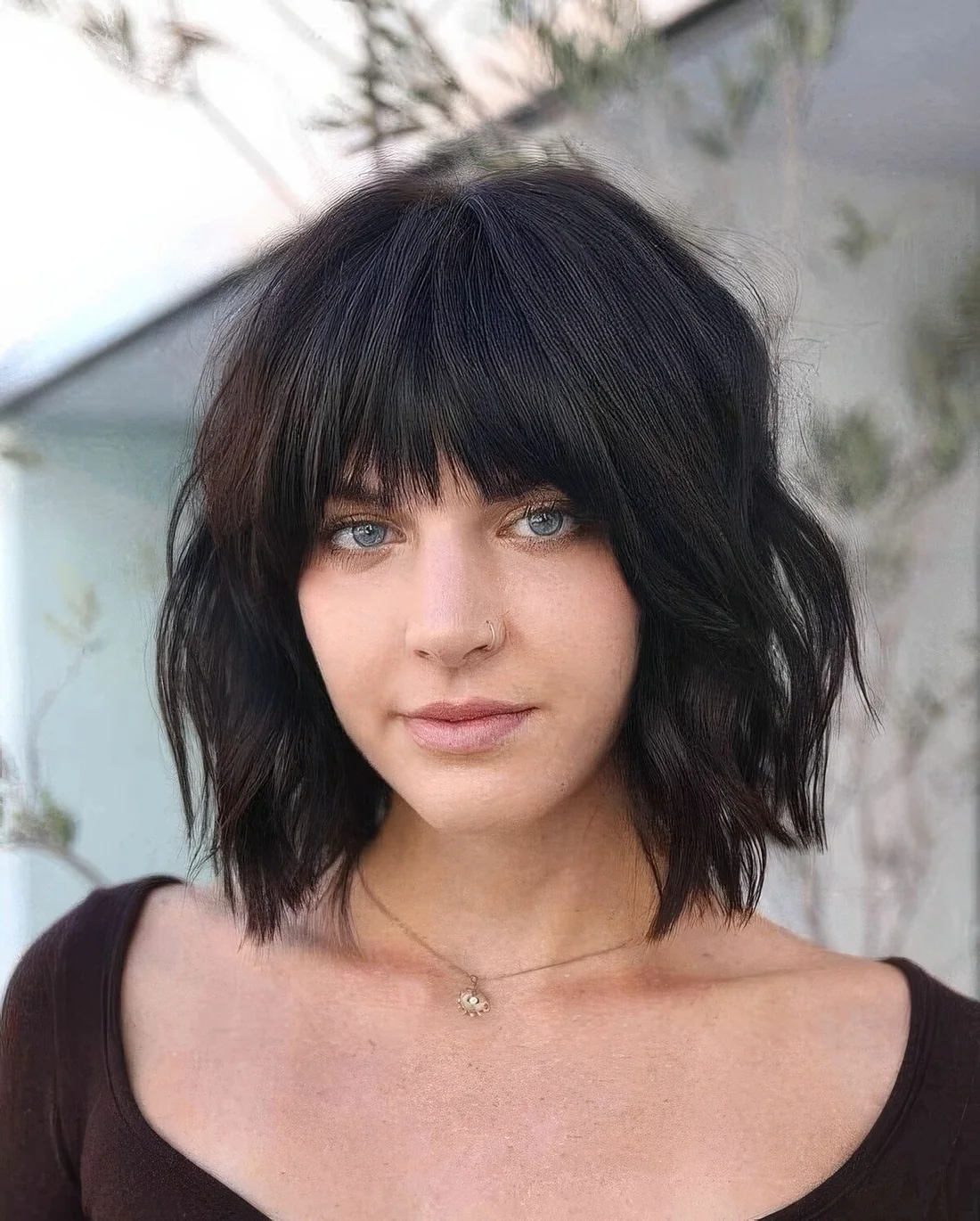 Black choppy bob with fringe bangs and waves.