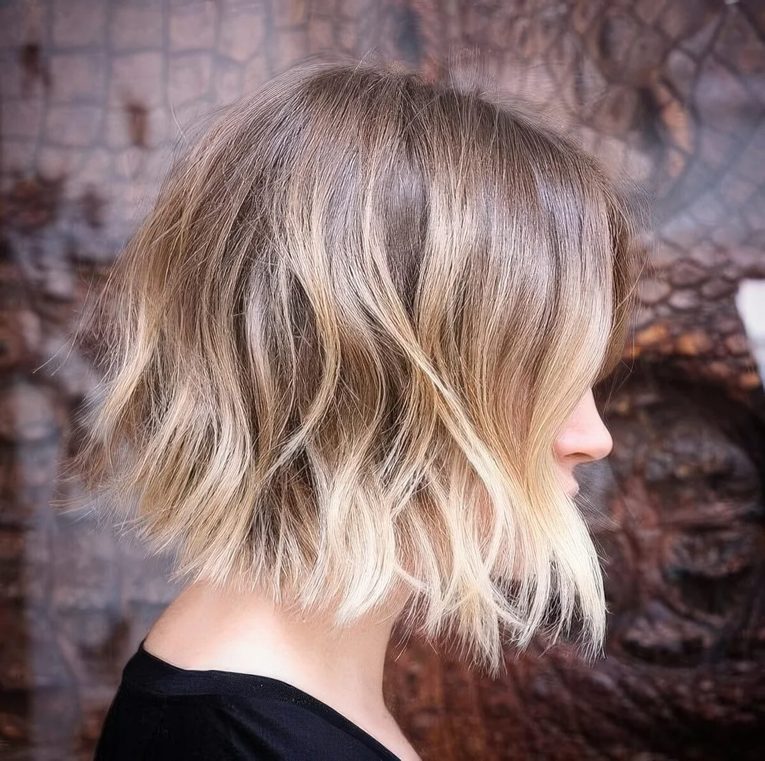 Chic light brunette wavy bob with blonde ombre and money piece.