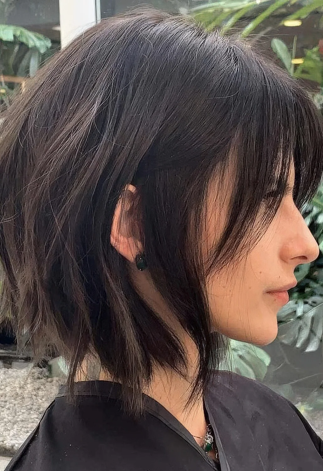 Choppy dark brunette bob with bangs and slight waves.